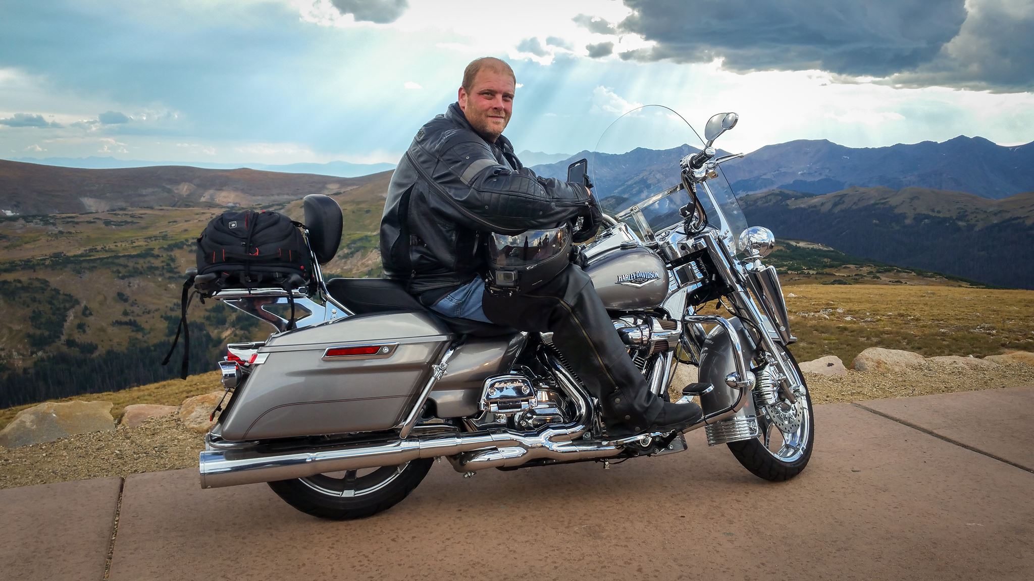 Chris Chase on his Harley-Davidson at a mountain summit